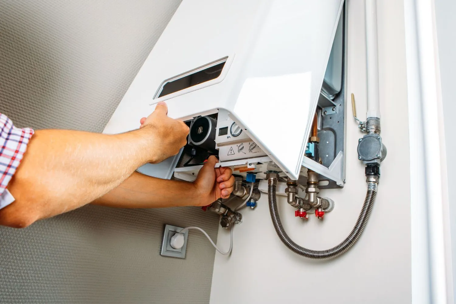 Plumber repairing a residential gas boiler
